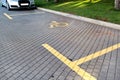 Post with disabled parking space and sign in front of parking bay in car park / Marked parking for people with special needs. Royalty Free Stock Photo