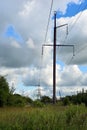 The post is electric. Power line in the countryside. High voltage electric pole against the sky. Electric station. Vertical Royalty Free Stock Photo