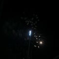 Post-fireworks smoke and clouds along football night lights