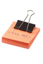 Post-it note with clip and message call me on white background