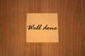 Post-it note Well done wooden background Royalty Free Stock Photo