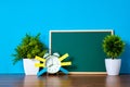 Post it note paper sticky and vintage alarm clock and blank green chalkboard on table with copy space for add text notice Royalty Free Stock Photo