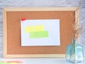 Post-it note pinned on a cork board with dried caspia in the vase Royalty Free Stock Photo