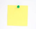 Yellow note pinned to white paper wall