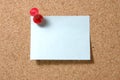 Post-it note with pushpin on corkboard Royalty Free Stock Photo