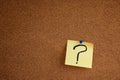 Post it note with question mark on bulletin board