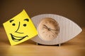 Post-it note with smiley face sticked on a clock