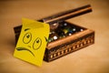 Post-it note with smiley face sticked on jewelry box