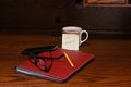 A post it note to do income taxes on desk with eye glasses pecil,notebook and cup Royalty Free Stock Photo