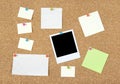 Post-it notes, papers and photo on a corkboard