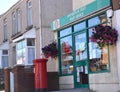 Post office entrance with red pillar box on Welsh street. Royalty Free Stock Photo