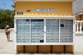 Post office mail boxes lining a wall outside and woman. El coptijo real. Spain. Royalty Free Stock Photo