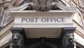 Post office sign, pan upwards. London, UK.