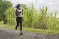 Post quarantine runner girl enjoying outdoors workout - young attractive and fit black African American woman running wearing face Royalty Free Stock Photo