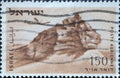 A post stamp printed in Israel showing den.Lion Rock, Negev with a propeller plane Royalty Free Stock Photo