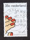 Post stamp printed in Netherlands braille and hand