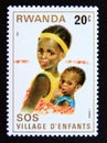 Postage stamp Rwanda, 1981. Mother carrying child