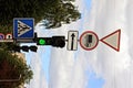 A post with traffic signs and a traffic light at a crossroads Royalty Free Stock Photo