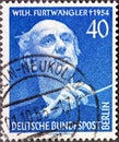 A postage stamp from Germany, Berlin showing Portrait of Wilhelm FurtwÃÂ¤ngler with baton. 1st anniver