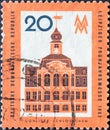 A postage stamp from Germany, GDR showing the historic Gohliser SchlÃÂ¶sschen house, trade fair sign in