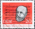 a postage stamp from Germany, GDR showing a portrait of the lyricist EugÃÂ¨ne Pottier before notes of t Royalty Free Stock Photo