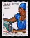 Postage stamp Guinea Bissau, 1984. Seamstress woman textile industry Royalty Free Stock Photo