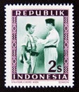 Postage stamp Indonesia, 1949. President Soekarno decorates a soldier
