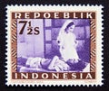 Postage stamp Indonesia, 1948. Red Cross nurse with wounded soldier