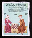 Postage stamp Laos, 1984. Margrave Otto IV of Brandenburg playing chess with his wife