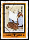 Postage stamp printed in Ajman (United Arab Emirates) shows Stamp from Japan, Man with newspaper, International Stamp Exhibition