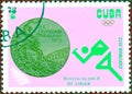 Postage stamp printed in Cuba with a picture of a light athletics and Olympic medal, with the inscription `Relay race 4x100 m` Royalty Free Stock Photo