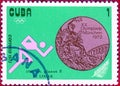 Postage stamp printed in Cuba with a picture of a light athletics and Olympic medal, with the inscription `Sprint 100 m`