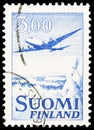 Postage stamp printed in Finland shows Aircraft Douglas DC-6 over Winter Landscape, Aircraft serie, circa 1958