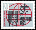 Postage stamp printed in Germany, shows Stylized ears of corn, seeds, cross and inscription, Misereor: Fight