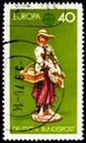 Postage stamp printed in Germany shows Girl selling trinkets and copperplate prints, Europa (C.E.P.T.) 1976 - Handicrafts serie,