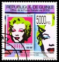 Postage stamp printed in Guinea shows Andy Warhol 1928-1987 ÃÂ«MarilynÃÂ» 1967, Marilyn Monroe and J.F. Kennedy on stamps, serie, Royalty Free Stock Photo