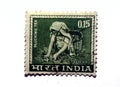 A postage stamp printed in India shows a woman plucking and picking tea circa 1965