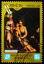 Postage stamp printed in Laos shows Rest on the Flight to Egypt with Saint Francis by Correggio, 450th Death Anniversary of