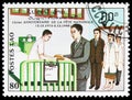Postage stamp printed in Laos shows Visiting the hospital, 15th Anniversary Of The People's Republic serie, circa 1990