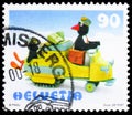 Postage stamp printed in Switzerland shows Papa & Pingu in post snowmobile, Pingu Comics Character serie, circa 1999