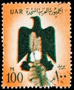 Postage stamp printed in UAR shows Eagle and hand - cotton and grain, National symbols serie, circa 1960