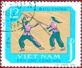 Postage stamp printed in Vietnam shows the national sport of of martial arts - Stick fighting, from the series `Sports