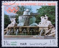 Postage stamp printed in Yemen in honor of the 1972 Munich Summer Olympics. The old Wittelsbach fountain at Lenbach square in Royalty Free Stock Photo