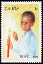 Postage stamp printed in Zaire Congo shows Child lightning a candle, Christmas serie, circa 1981