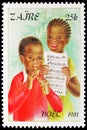 Postage stamp printed in Zaire Congo shows Children playing a flute, Christmas serie, circa 1981