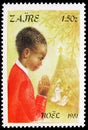 Postage stamp printed in Zaire Congo shows Praying child, Christmas serie, circa 1981