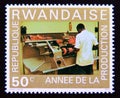 Postage stamp Rwanda, 1975. Factory Worker at a Machine