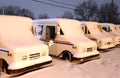 Postal Delivery Trucks Covered in Snow