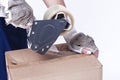 Postal and Moving. Closeup of Female Hands Packing Cardboard Box Indoors Unsing A Tape-Machine Royalty Free Stock Photo