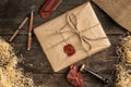 a postal parcel wrapped in wrapping paper and tied with ropes with a sealing wax seal lies Royalty Free Stock Photo